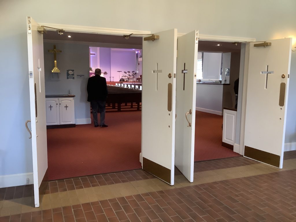 Open doors leading to sanctuary and pastor at Yorkshire Church